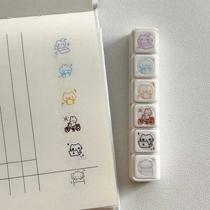 Tampon scrapbooking Joie, tampons transparents et empreintes kawaii sur un carnet ligné