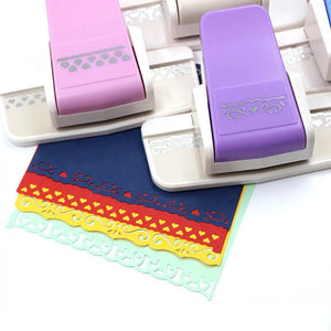 Perforatrice bordure scrapbooking et cinq frises décoratives en papier coloré, cœurs et volutes