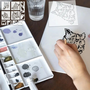 Pochoir chats peint en noir au pinceau, palette aquarelle multicolore en avant-plan