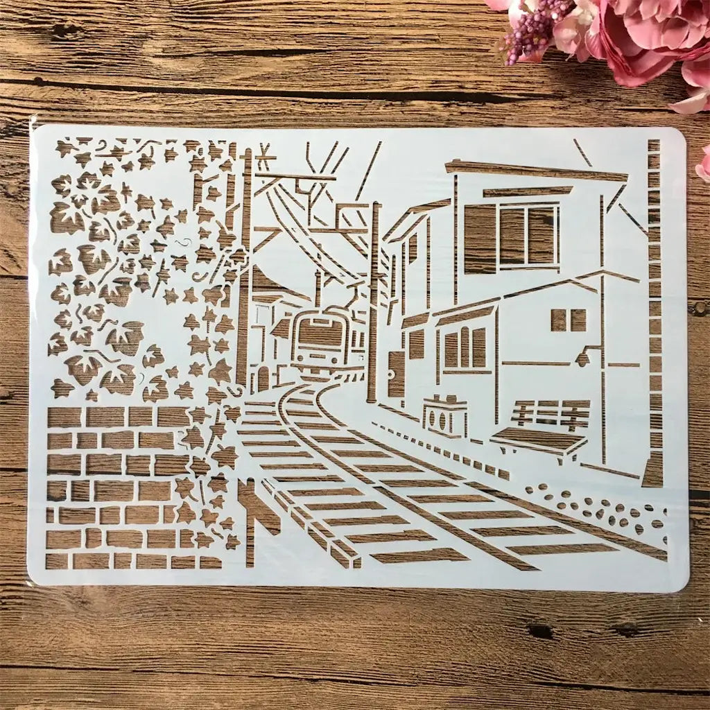 Pochoir scène de rue maisons et rails sous arbre fleuri pour scrapbooking urbain