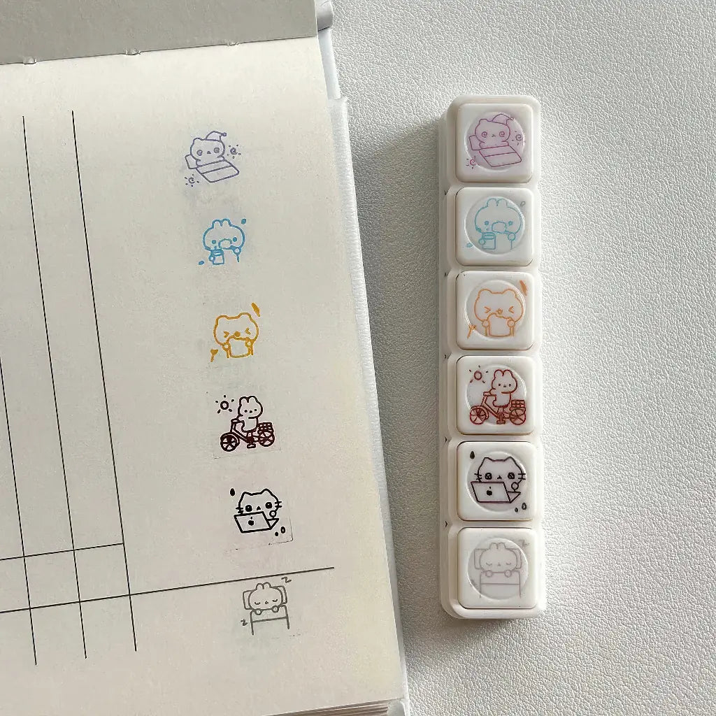 Tampon scrapbooking Joie, tampons transparents et empreintes kawaii sur un carnet ligné